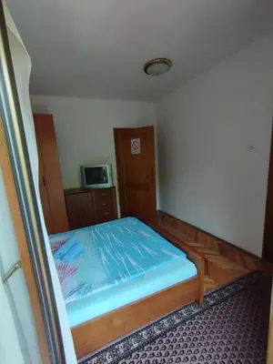 a small bedroom with a bed with blue sheets at VILA MARKO in Niška Banja