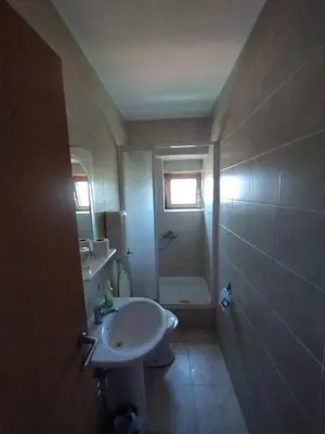 a bathroom with a sink and a toilet and a window at VILA MARKO in Niška Banja