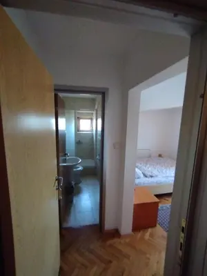 an empty room with a bed and a bathroom at VILA MARKO in Niška Banja