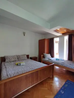 a bedroom with two beds and a window at VILA MARKO in Niška Banja