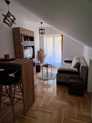 a living room with a couch and a table at Apartman Bošković Vrnjačka Banja in Vrnjačka Banja