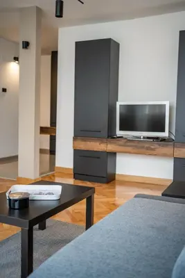 a living room with a tv and a coffee table at Dora in Bor