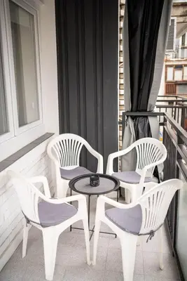 four chairs and a table on a balcony at Dora in Bor