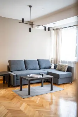 a living room with a blue couch and a table at Dora in Bor