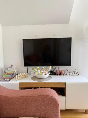 a living room with a television on a white table at Aleksandar apartman Sokobanja in Soko Banja