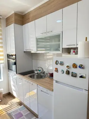 a kitchen with white cabinets and a sink at Aleksandar apartman Sokobanja in Soko Banja