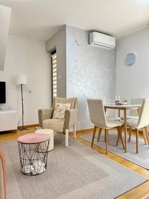 a living room with a couch and a table and chairs at Aleksandar apartman Sokobanja in Soko Banja