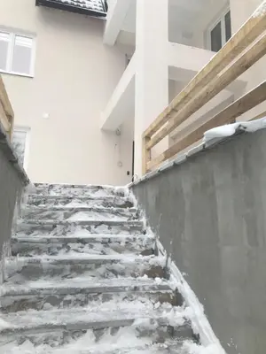 a snow covered staircase in front of a building at Pekakop Treska in Kopaonik