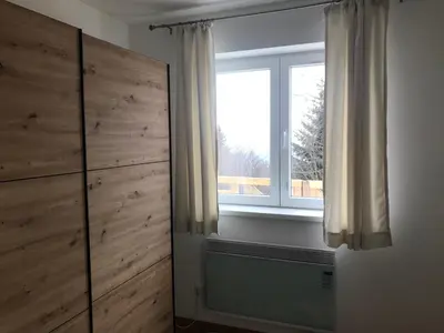a bedroom with a large window and a dresser at Pekakop Treska in Kopaonik