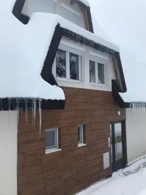 a building covered in snow with icicles on it at Pekakop Treska in Kopaonik