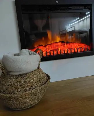 a basket sitting in front of a fireplace at Apartman Anastasija Vrnjačka Banja in Vrnjačka Banja