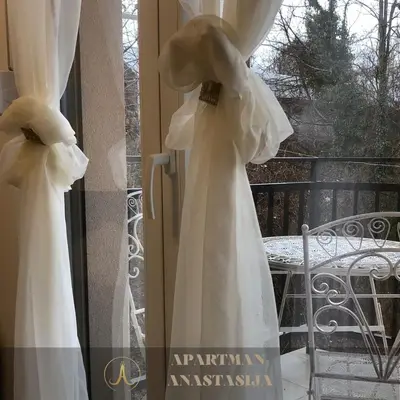 a bride in a white wedding dress on a window at Apartman Anastasija Vrnjačka Banja in Vrnjačka Banja