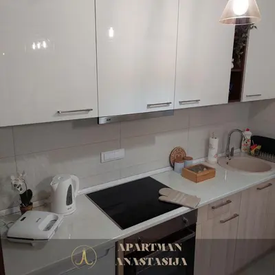a kitchen with white cabinets and a sink at Apartman Anastasija Vrnjačka Banja in Vrnjačka Banja