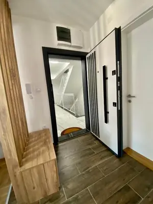 a hallway with a sliding glass door and stairs at APARTMAN TAMARA LUX in Vrnjačka Banja