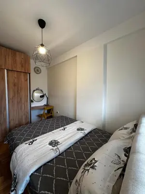 a bedroom with two beds and a light fixture at Sweet Dreams & Free parking in Vrnjačka Banja