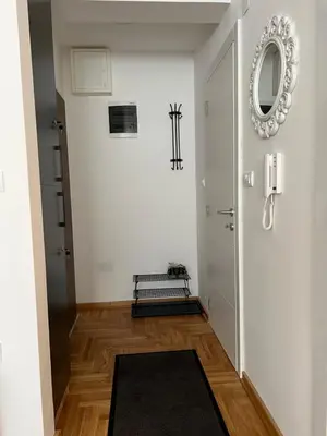 a hallway with a door and a mirror on the wall at Sweet Dreams & Free parking in Vrnjačka Banja