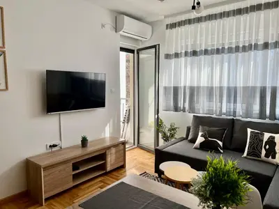 a living room with a couch and a tv at Sweet Dreams & Free parking in Vrnjačka Banja