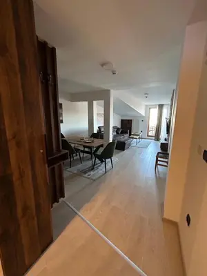 a view of a living room and dining room at Milmari Apartments & SPA - N Lux 108 in Kopaonik