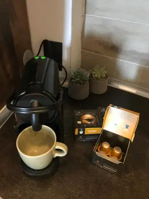 a coffee maker and a cup of coffee on a counter at Milmari Apartments & SPA - N Lux 108 in Kopaonik