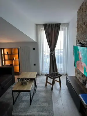 a living room with a couch and a tv at Milmari Apartments & SPA - N Lux 108 in Kopaonik