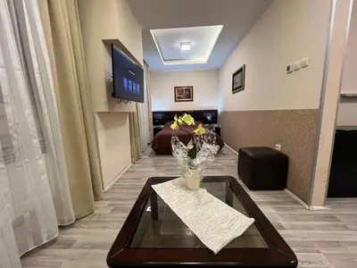 a lobby with a vase of flowers on a table at Hotel Petrus in Paraćin