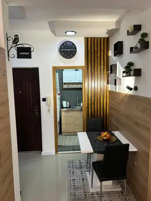 a kitchen and dining room with a table and chairs at Family Apartment in Niš