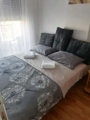 a bed with two pillows on it in a bedroom at Apartman BojAna Vrnjačka Banja in Vrnjačka Banja