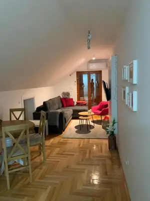 a living room with a couch and a table at Vrnjački apartman in Vrnjačka Banja