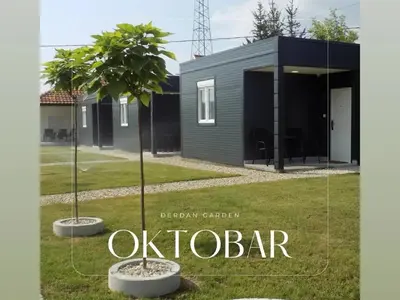a modern house with two trees in a yard at Đerdan Garden apartments in Kraljevo