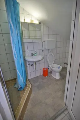a bathroom with a toilet and a sink at Apartmani Lazić in Ribarska Banja