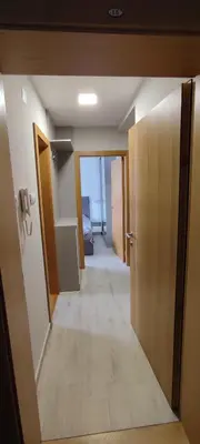 a hallway of a room with a door and a hallway at Jela Apartman in Soko Banja