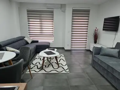 a living room with a couch and a table at Silver city studio in Jagodina