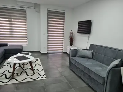 a living room with a couch and a table at Silver city studio in Jagodina