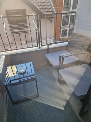 a balcony with a table and a chair at Silver city studio in Jagodina