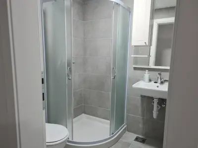 a bathroom with a shower and a toilet and a sink at Silver city studio in Jagodina