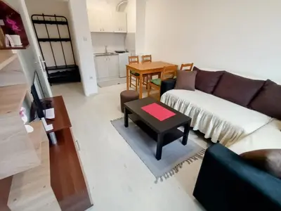a living room with a couch and a table at Apartman Rubi Sokobanja in Soko Banja