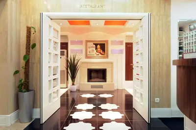 a living room with a fireplace and a tile floor at Garni Hotel Crystal in Kraljevo