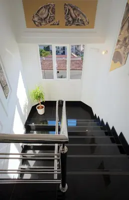 a staircase with a table and a potted plant at Garni Hotel Crystal in Kraljevo