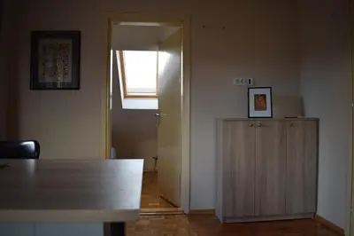 a room with a table and a door with a window at Apartmani Filip in Vrnjci