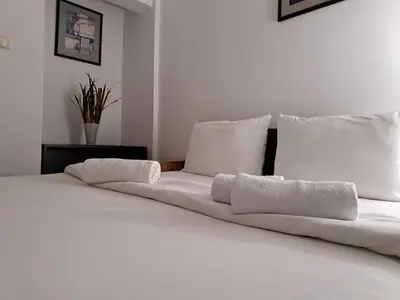 a white bed with two white pillows on it at Hotel Marica in Niš