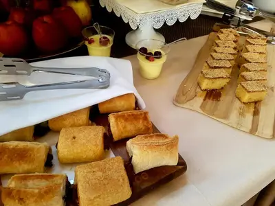 a table with a bunch of bread on a cutting board at Hotel Marica in Niš