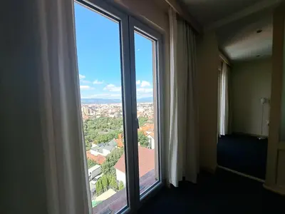 a window in a hotel room looking out at the city at Hotel Marica in Niš
