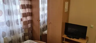 a room with a television and a window with a curtain at Vila Dubrovnik in Vrnjačka Banja