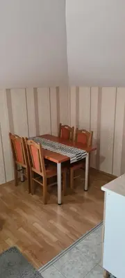 a wooden table with chairs and a table and a table and chairsktop at Vila Dubrovnik in Vrnjačka Banja