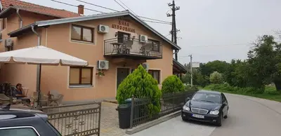 a car parked in front of a house at Vila Dubrovnik in Vrnjačka Banja