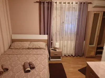 a bedroom with a bed with shoes on it at Vila Dubrovnik in Vrnjačka Banja