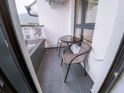 a balcony with two chairs and a table at Apartman Bellini 2 in Soko Banja