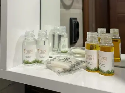 a shelf with four bottles of essential oils on it at Apartmani Bosfor in Niška Banja