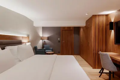 a hotel room with a bed and a desk at Hotel Grand Kopaonik in Kopaonik