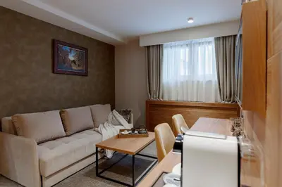 a living room with a couch and a table at Hotel Grand Kopaonik in Kopaonik